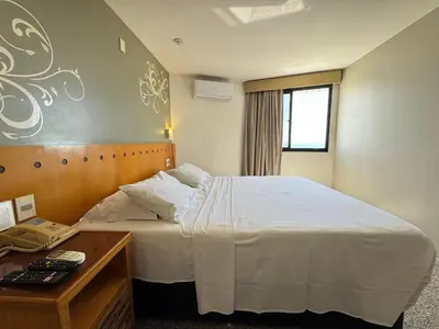 Uma cama ou camas num quarto em Flat Blue Tree Beira Mar by Escala