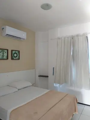 Uma cama ou camas num quarto em Brisa Brasil Residence