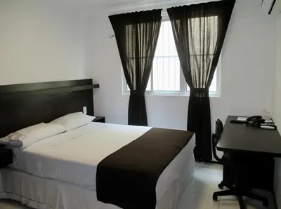 Uma cama ou camas num quarto em Hotel Sol Brasil