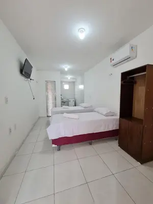 Uma cama ou camas num quarto em Pousada Jereissati