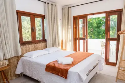 Uma cama ou camas num quarto em Casa Blue Parrot – Um Paraíso na Praia da Taíba