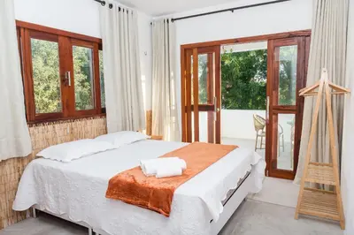 Uma cama ou camas num quarto em Casa Blue Parrot – Um Paraíso na Praia da Taíba