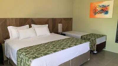 Uma cama ou camas num quarto em CHEZ TUPÃ SUÍTES
