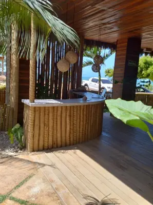 Um jardim no exterior de Villa Caravelas Praia de Moitas
