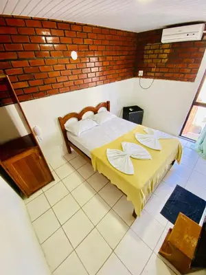 Uma cama ou camas num quarto em Felicità Praia Hotel
