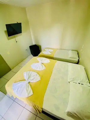 Uma cama ou camas num quarto em Felicità Praia Hotel