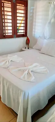 Uma cama ou camas num quarto em Pousada dos Anjos Paracuru