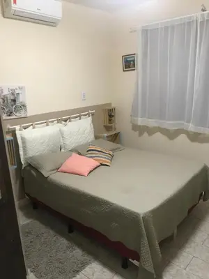 Uma cama ou camas num quarto em Pousada Suítes Meireles