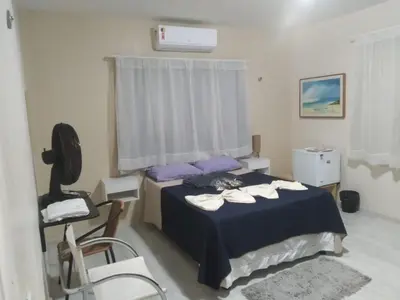 Uma cama ou camas num quarto em Pousada Suítes Meireles