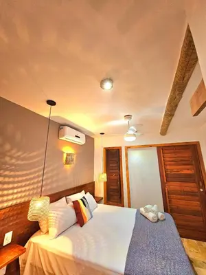 Uma cama ou camas num quarto em Chalés Mahalo J - Pontal de Maceió - Fortim