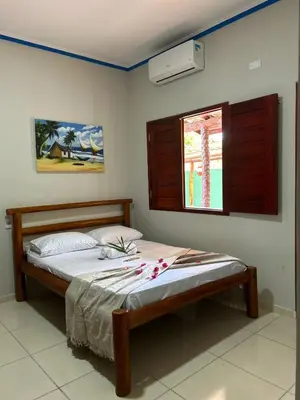 Uma cama ou camas num quarto em Pousada Imperio dos Bambus