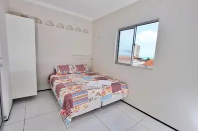 Uma cama ou camas num quarto em Residencial Santa Lucia