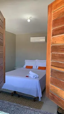 Uma cama ou camas num quarto em Pousadinha no Paracuru