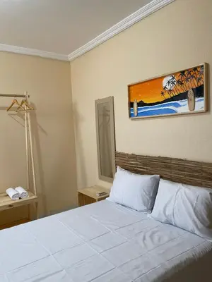 Uma cama ou camas num quarto em Pousada perto do mar