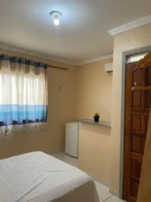 Uma cama ou camas num quarto em Pousada perto do mar