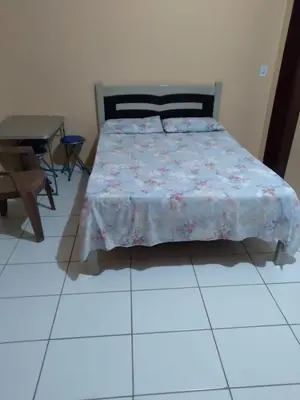 Uma cama ou camas num quarto em kitinete - SALVATERRA GUARAMIRANGA