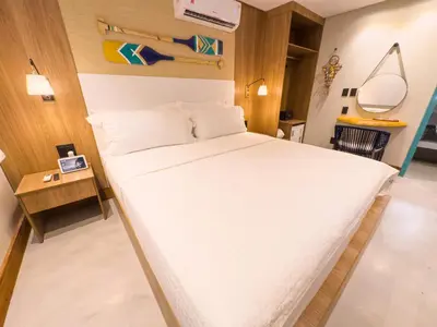 Uma cama ou camas num quarto em Poozendin Hotel de Charme