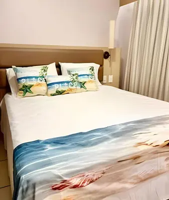 Uma cama ou camas num quarto em Apartamento em Beach Class Praia de Iracema Por CasAmarInn
