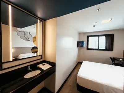 Uma cama ou camas num quarto em WA HOTEL FORTALEZA