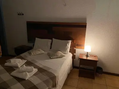 Uma cama ou camas num quarto em Pousada Villa Flamboyant