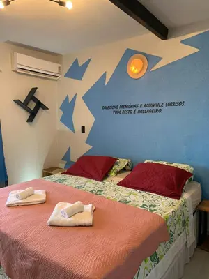 Uma cama ou camas num quarto em Pousada Villa Flamboyant