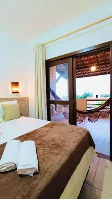 Uma cama ou camas num quarto em Flat Malua - Apartamento Pé Na Areia Com Vista Mar Taíba-CE