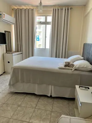 Uma cama ou camas num quarto em Stúdio Beira Mar
