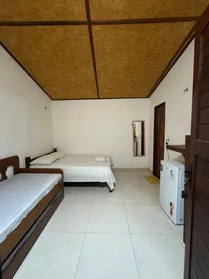 Uma cama ou camas num quarto em Flechimar Suítes