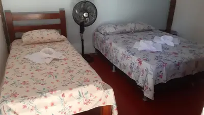 Uma cama ou camas num quarto em Vivenda Mar Doce Lar - Casa de Temporada