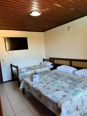 Uma cama ou camas num quarto em Pousada Navegantes Beach