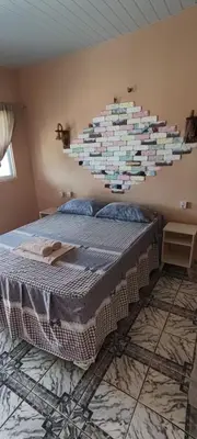Uma cama ou camas num quarto em Aloha pousada & restaurante