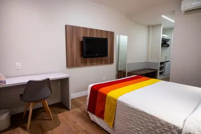 Uma cama ou camas num quarto em Hotel Praia Centro