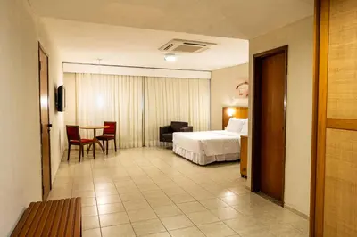 Uma cama ou camas num quarto em Hotel Praia Centro
