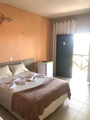 Uma cama ou camas num quarto em Pousada Vila do Pôr do Sol Canoa Quebrada