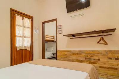 Uma cama ou camas num quarto em Pousada Villa Tomasi