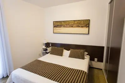 Uma cama ou camas num quarto em Hotel Brasil Tropical