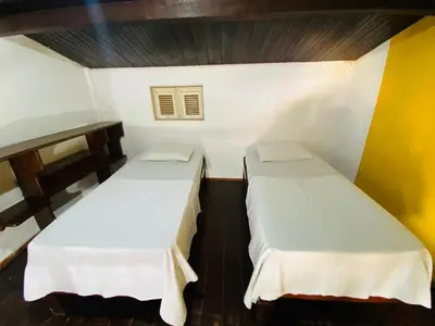 Uma cama ou camas num quarto em Pousada Tropicalia