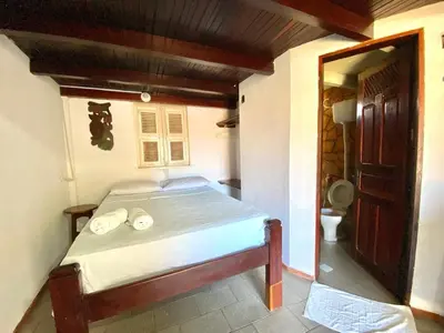 Uma cama ou camas num quarto em Pousada Tropicalia