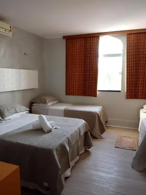 Uma cama ou camas num quarto em Pousada Areia da Praia