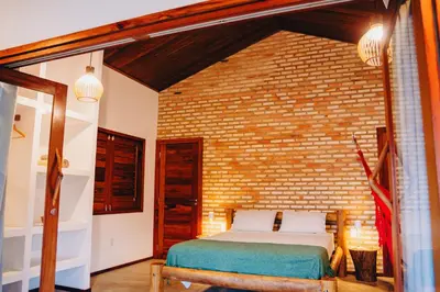 Uma cama ou camas num quarto em Casa de Coco Icarai
