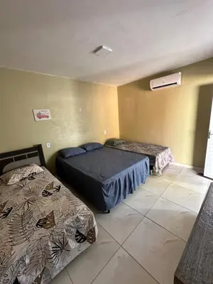 Uma cama ou camas num quarto em Pousada Vó Maria