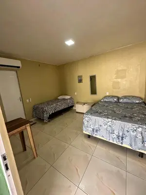 Uma cama ou camas num quarto em Pousada Vó Maria