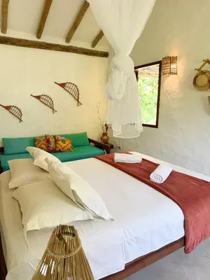 Uma cama ou camas num quarto em Casa Peroá Pousada