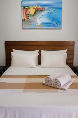 Uma cama ou camas num quarto em Pousada o pescador