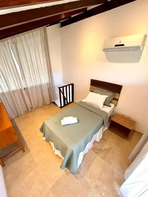 Uma cama ou camas num quarto em CASA TAÍBA BEACH RESORT PÉ Na AREIA - IMOB TEMPORADA