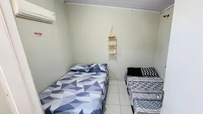 Uma cama ou camas num quarto em L1 localize casa na praia