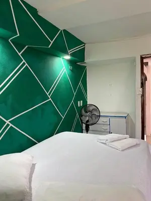 Uma cama ou camas num quarto em Pousada Oásis