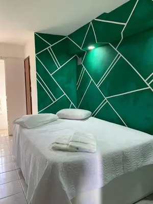 Uma cama ou camas num quarto em Pousada Oásis