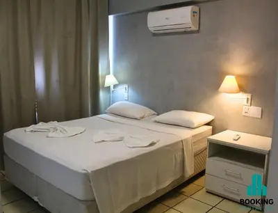 Uma cama ou camas num quarto em Estoril Praia de Iracema