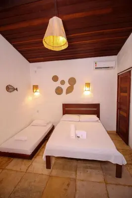 Uma cama ou camas num quarto em Palm Beach Pousada - Praia de Caetanos Quarto Casal ou Triplo